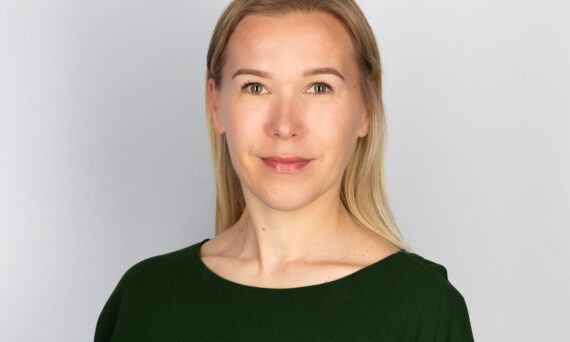 Anna Autti, blond woman in black top facing forwards.
