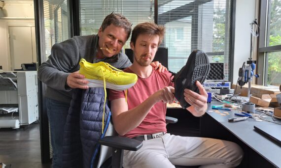 Ofir Dagan and Nicolas Barattolo holding trainers in their hand